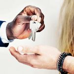 real estate agent giving homeowner keys