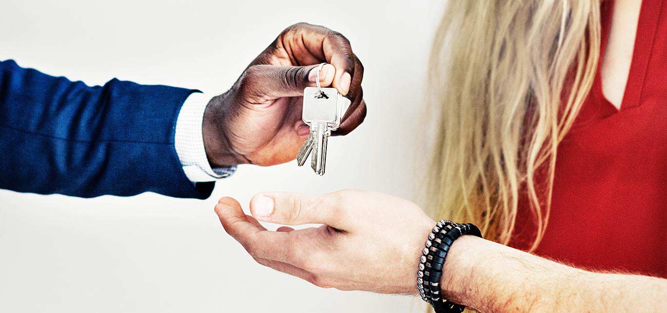 real estate agent giving homeowner keys