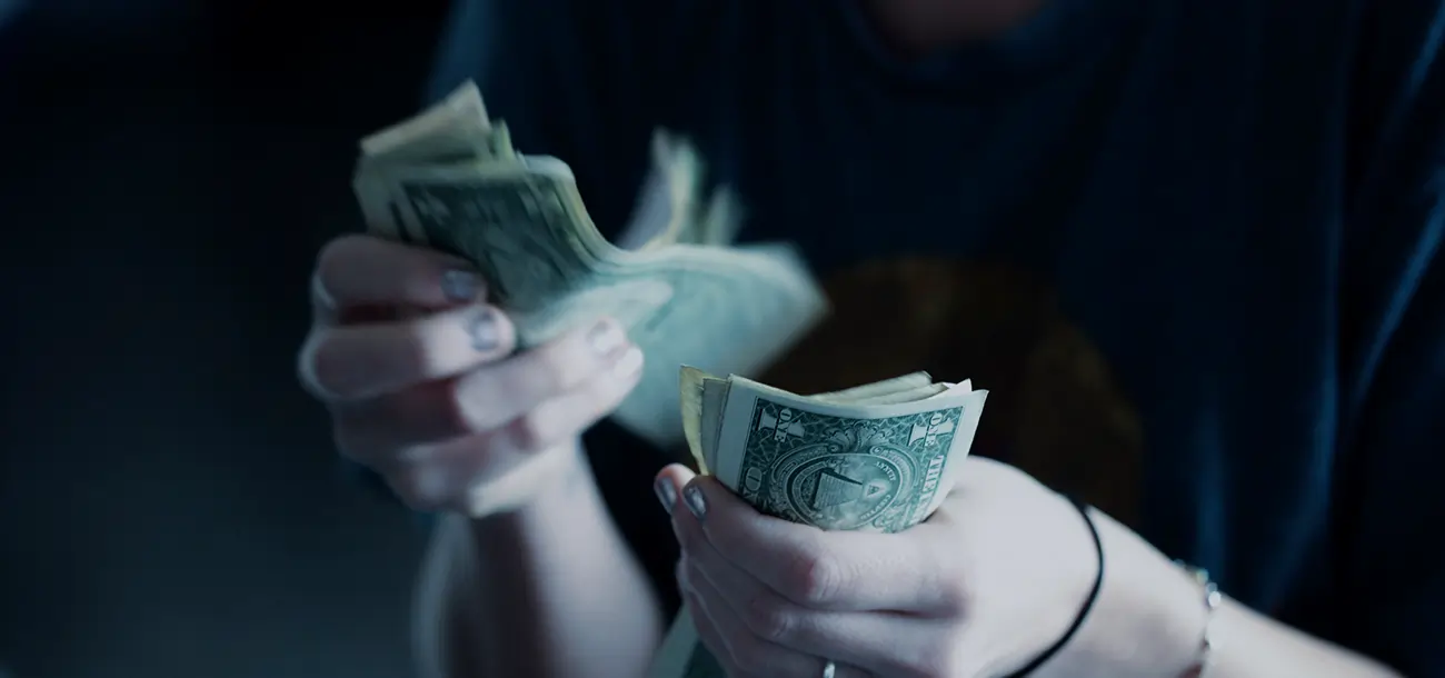 Close up of woman's hand counting cash for small business loans
